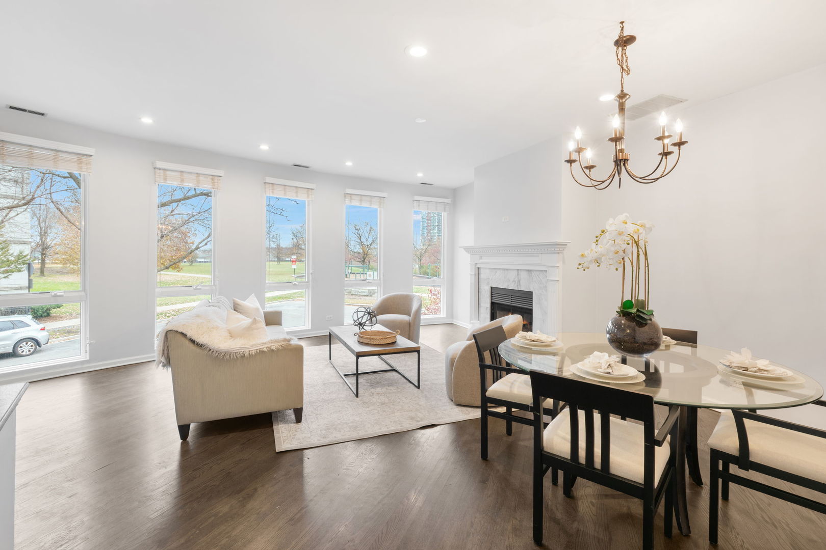 1522 South Prairie Avenue, Unit H Chicago, IL 60605 - Photo 4 of 25 a dining room with wooden floor a chandelier a glass table and chairs