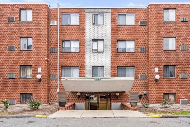 a front view of a building with a table and chairs