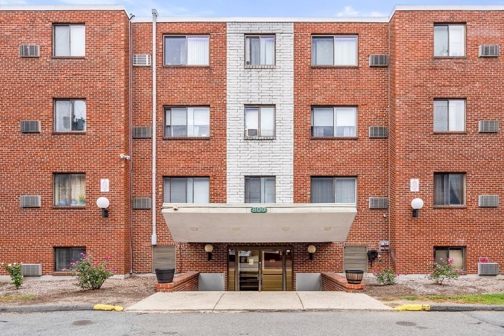 a front view of a building with a table and chairs