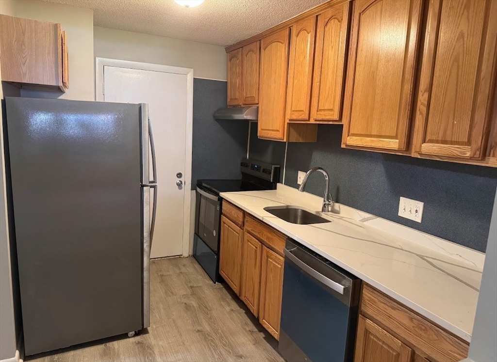 800 Governors Drive, Unit 7 Winthrop, MA 02152 - Photo 11 of 27 a kitchen with a refrigerator and a sink