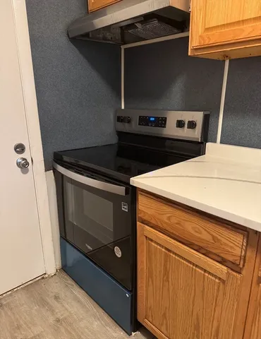 a stove top oven sitting inside of a kitchen