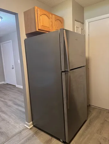 a white refrigerator freezer sitting in a kitchen