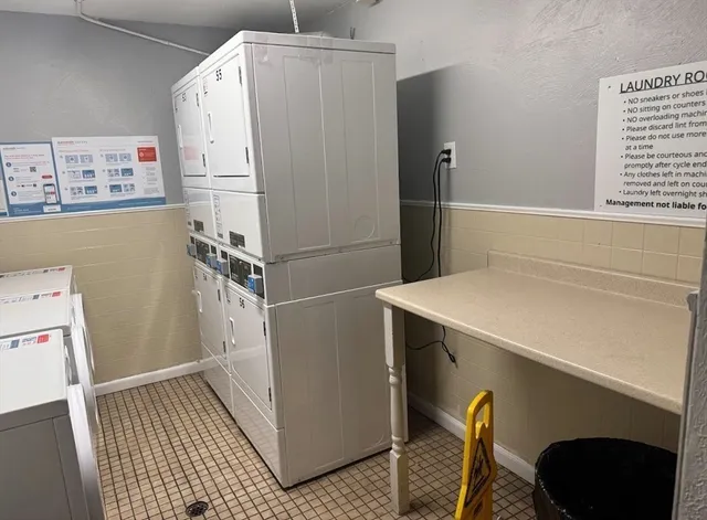 a white refrigerator freezer and a stove sitting inside of a kitchen