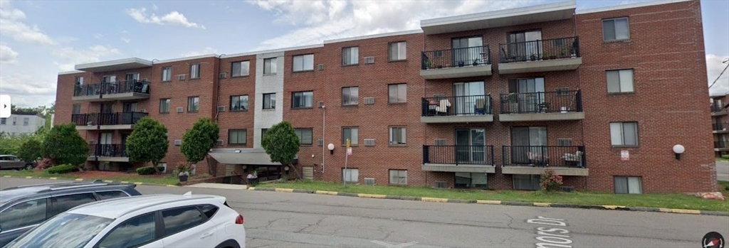 800 Governors Drive, Unit 7 Winthrop, MA 02152 - Photo 25 of 27 a front view of a building with a garden and plants