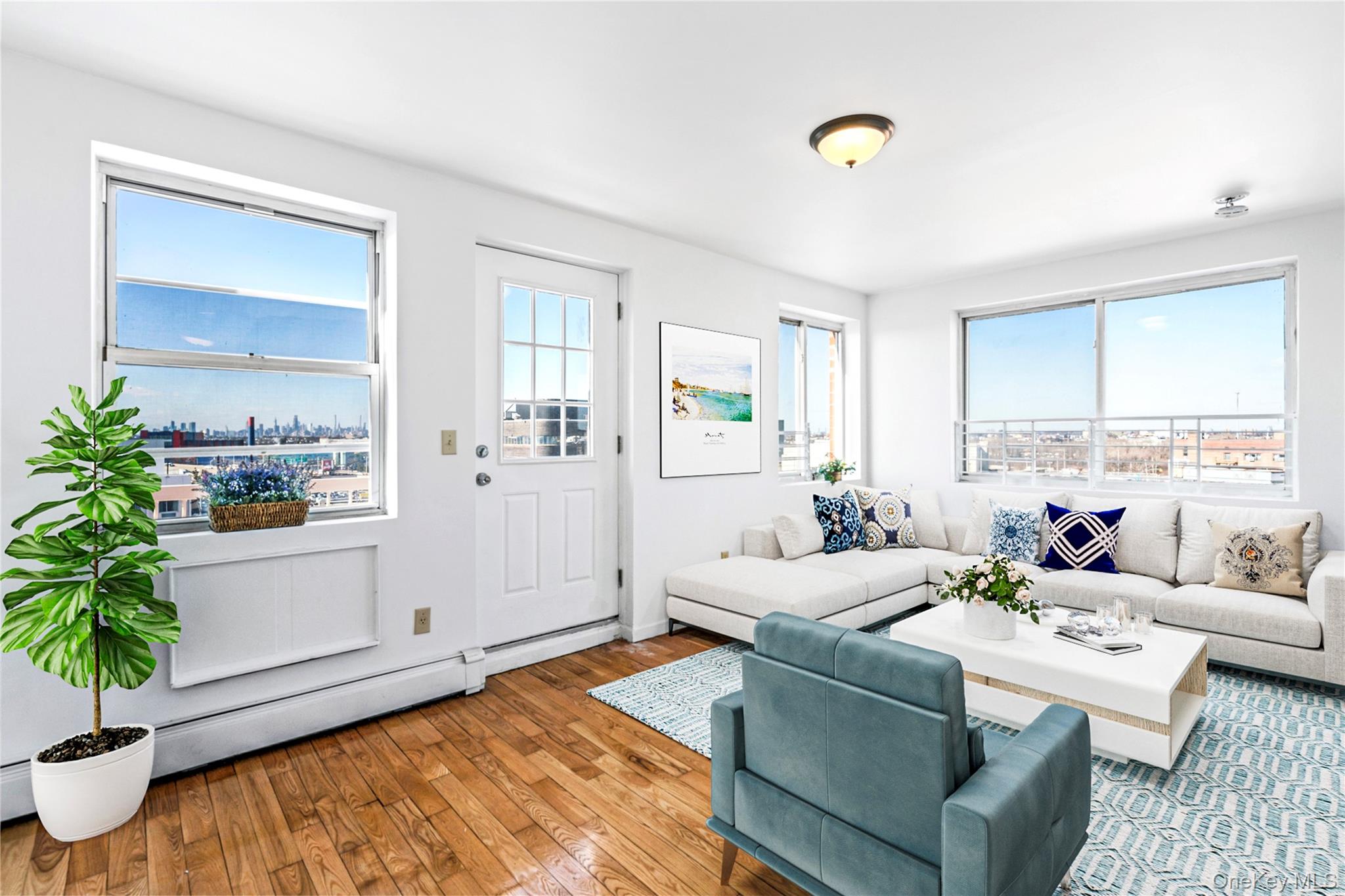 136-16 31st Road, Unit 8B Queens, NY 11354 - Photo 8 of 23 Virtual Staged Living area with healthy amount of natural light and hardwood / wood-style flooring