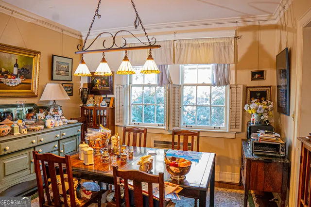 a dining room with furniture a chandelier and window