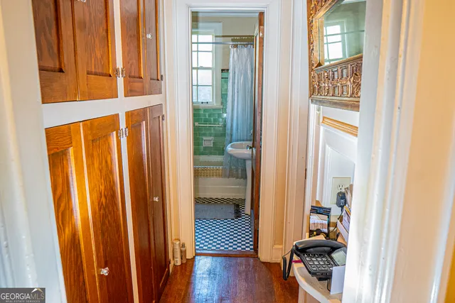 a view of a closet area with wooden floor