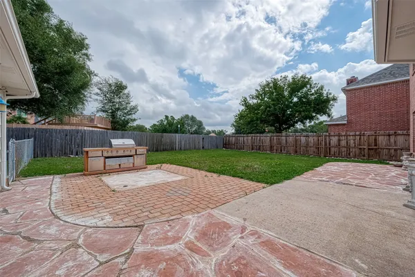 a view of a backyard with wooden fence