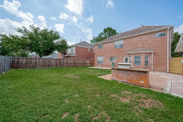 a view of a house with a yard patio and sitting area