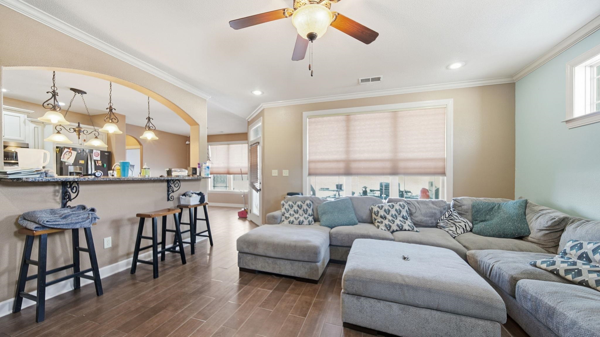 a living room with furniture and wooden floor