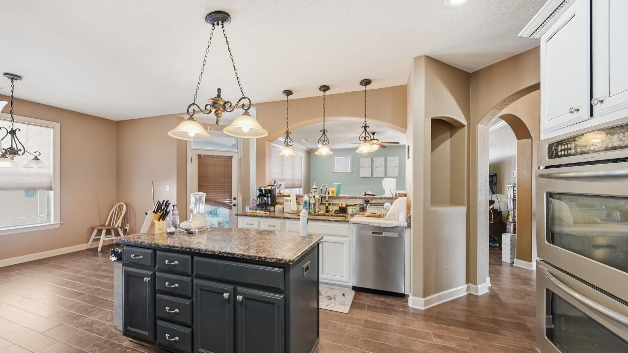 34 Carson Cove Atoka, TN 38004 - Photo 11 of 27 a kitchen with stainless steel appliances granite countertop a refrigerator a sink dishwasher a dining table and chairs with wooden floor