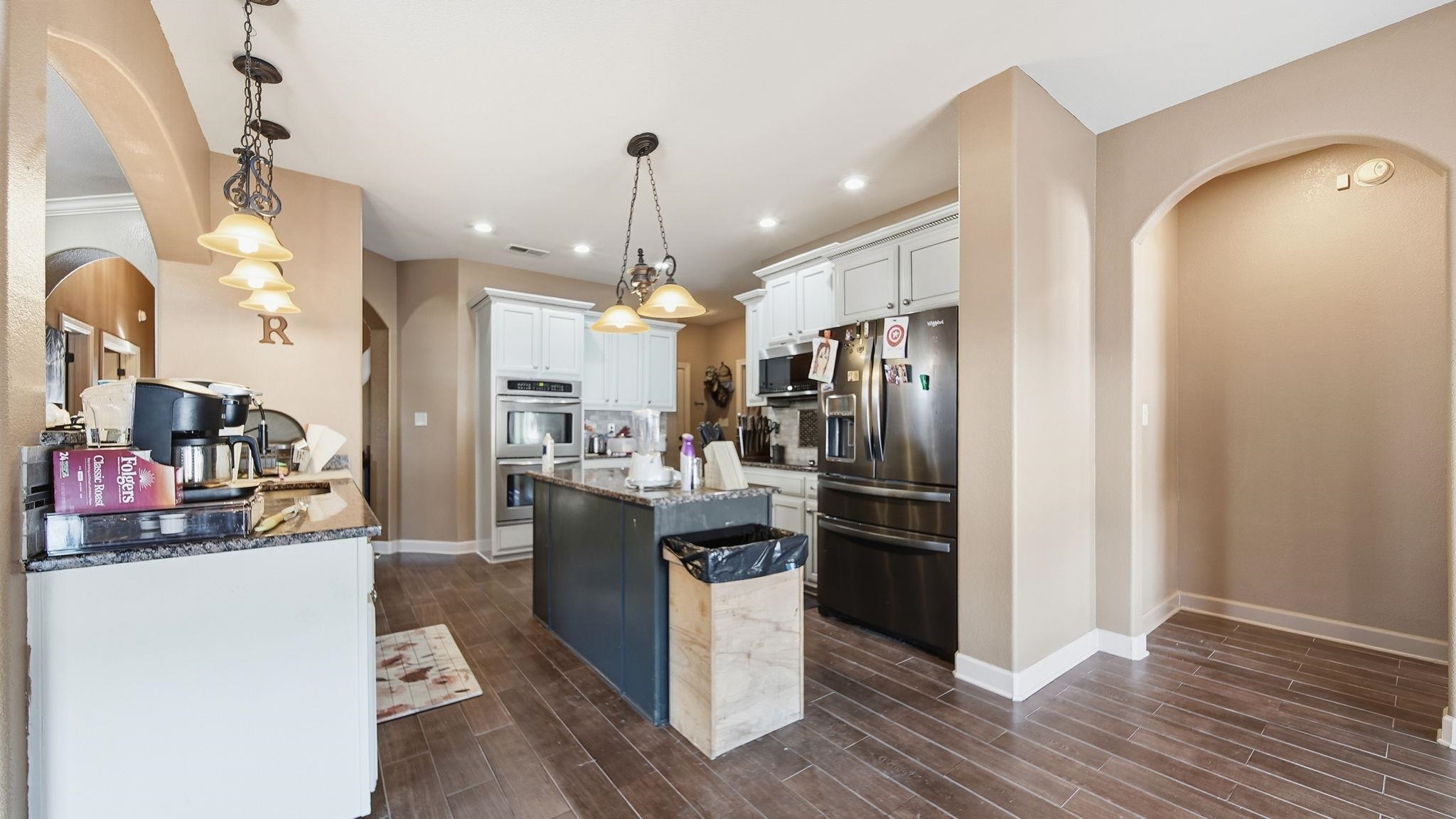 34 Carson Cove Atoka, TN 38004 - Photo 10 of 27 a kitchen with stainless steel appliances kitchen island granite countertop a refrigerator and a wooden floor