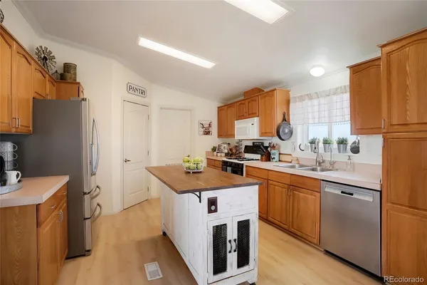 a kitchen with a sink stove and refrigerator
