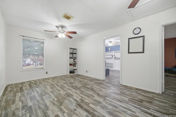 a view of a bedroom with a bed and a chandelier fan