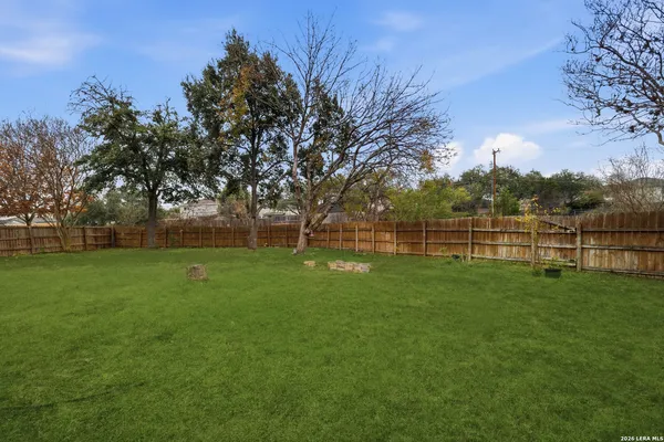 a view of a field of grass and trees