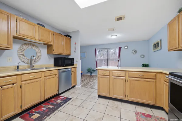 a kitchen with granite countertop cabinets and white appliances