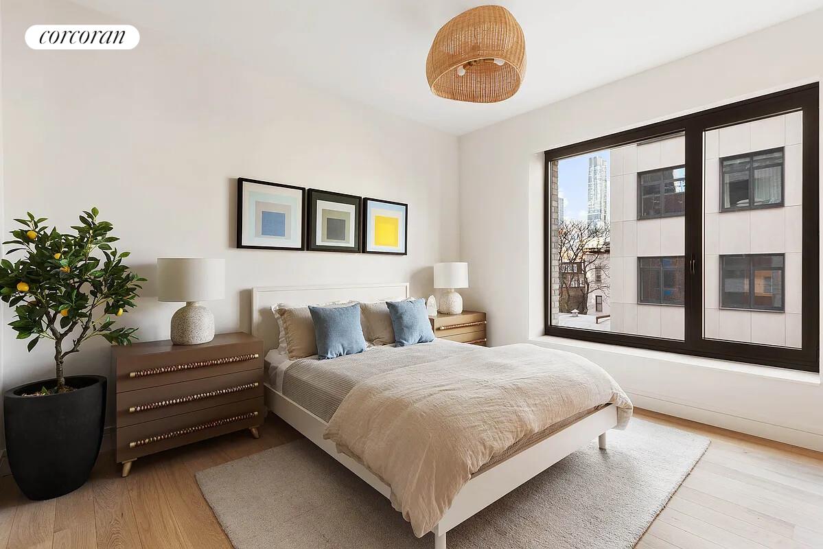 428 West 19th Street, Unit 4D Manhattan, NY 10011 - Photo 5 of 15 a bedroom with a bed and a large window
