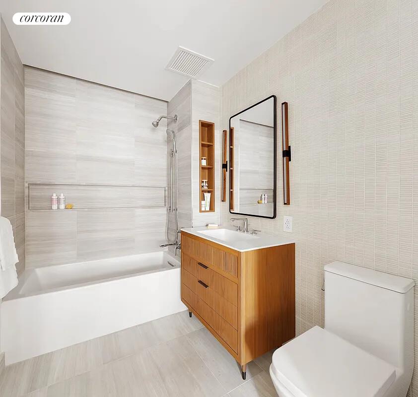 428 West 19th Street, Unit 4D Manhattan, NY 10011 - Photo 6 of 15 a bathroom with a toilet a sink and a bathtub
