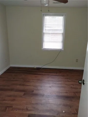 a view of a room with wooden floor and window