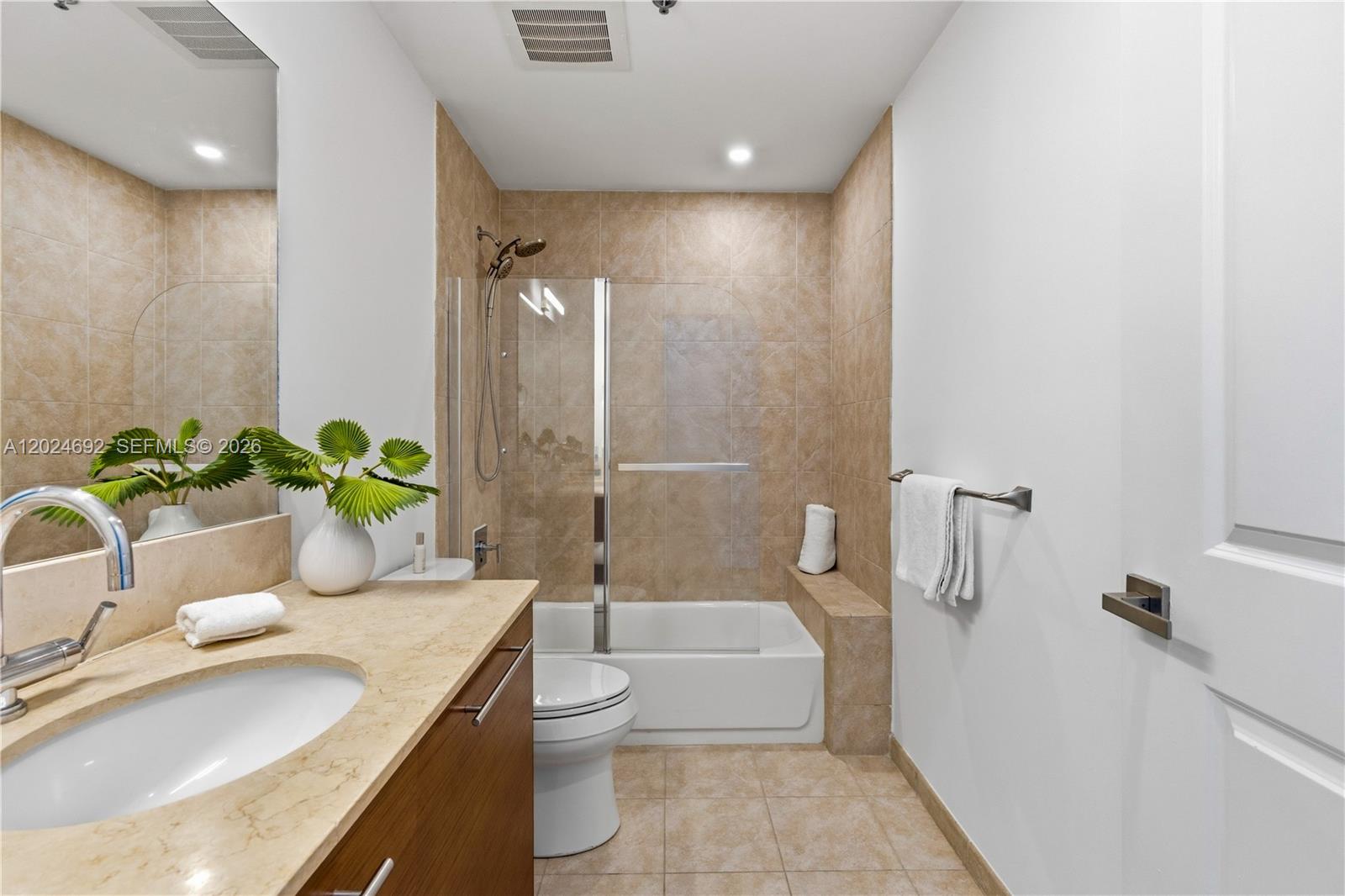 2641 North Flamingo Road, Unit 2605N Sunrise, FL 33323 - Photo 16 of 56 a bathroom with a granite countertop sink a toilet and shower