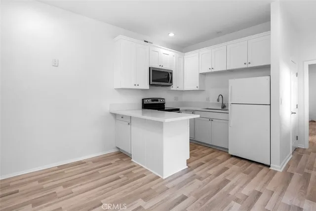 a kitchen with a sink cabinets and a window