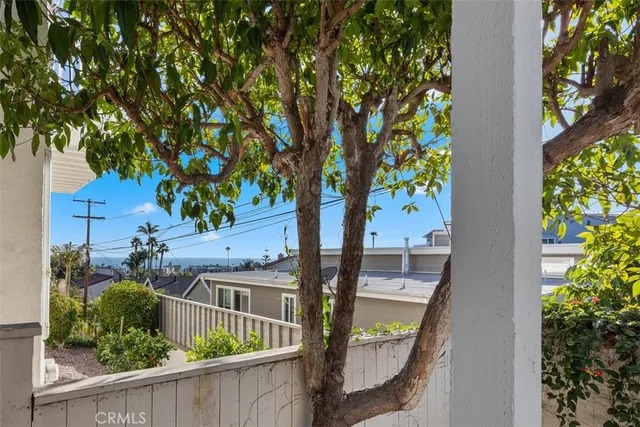 a view of a house with a tree in front of it