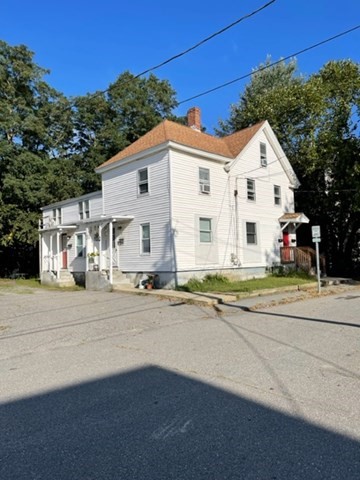 20 West Street, Unit 3 Ayer, MA 01432 - Photo 1 of 1 a view of a white house with a yard