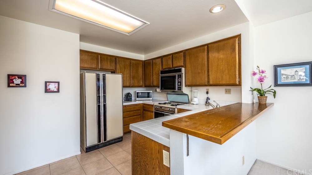 3540 Vista Glen Circle Yorba Linda, CA 92886 - Photo 10 of 31 a kitchen with a refrigerator a stove a microwave a sink and cabinets