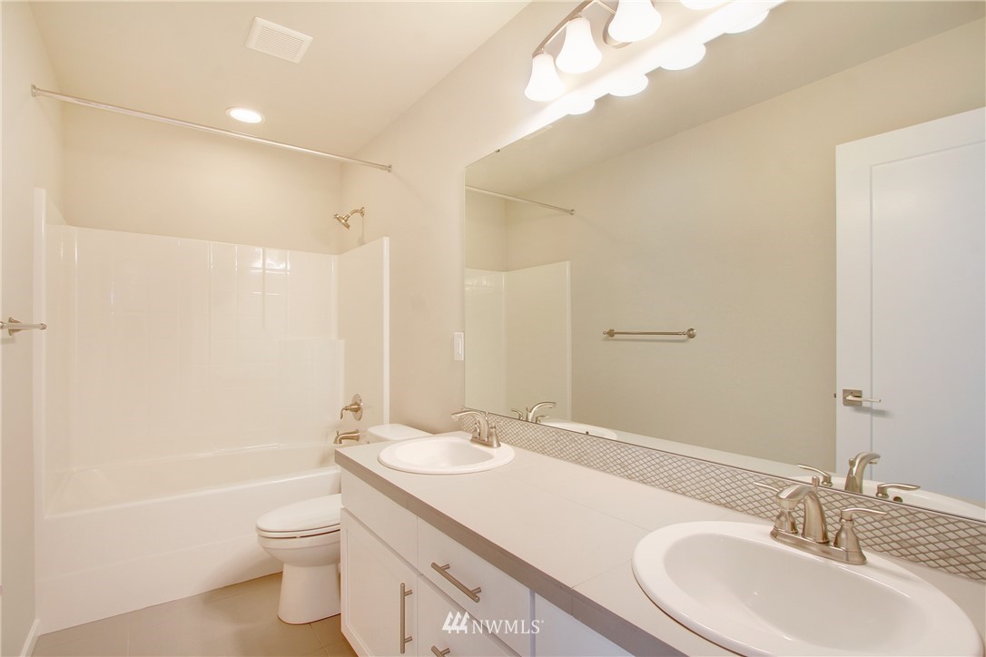 210 180th Place Southwest, Unit CT 01 Bothell, WA 98012 - Photo 14 of 19 a bathroom with a granite countertop sink toilet and shower