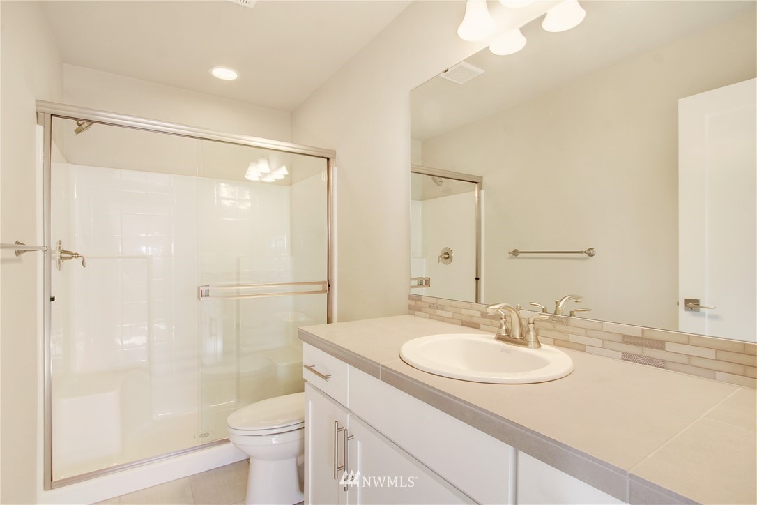 210 180th Place Southwest, Unit CT 01 Bothell, WA 98012 - Photo 16 of 19 a bathroom with a sink toilet a mirror and shower