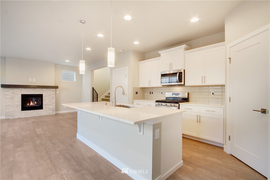 210 180th Place Southwest, Unit CT 01 Bothell, WA 98012 - Photo 5 of 19 a kitchen with a sink stainless steel appliances and white cabinets