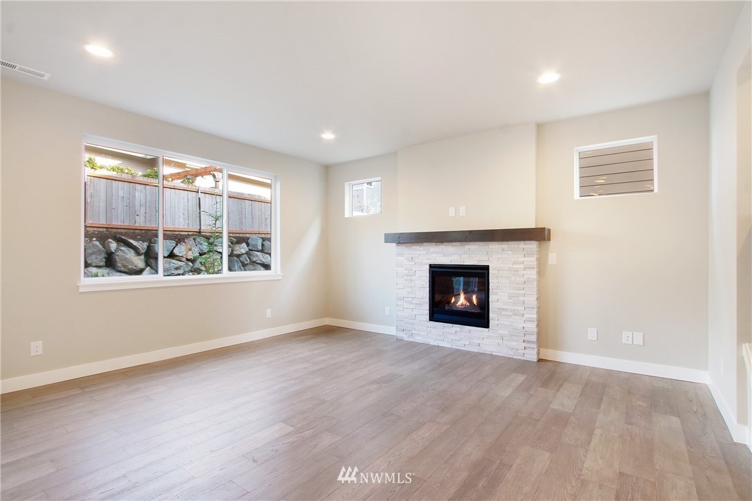210 180th Place Southwest, Unit CT 01 Bothell, WA 98012 - Photo 6 of 19 an empty room with windows and fireplace