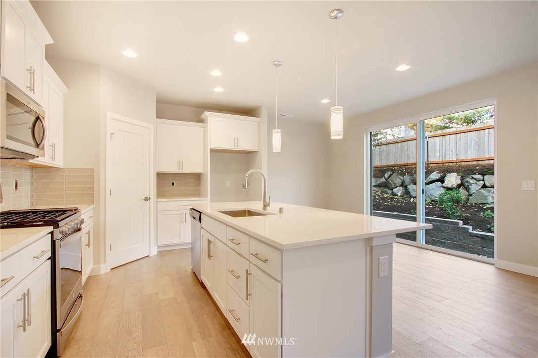 210 180th Place Southwest, Unit CT 01 Bothell, WA 98012 - Photo 7 of 19 a kitchen with a sink stove and wooden floor
