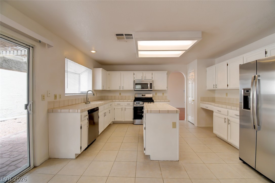 5 Tarryall Terrace Henderson, NV 89074 - Photo 22 of 44 Functional kitchen with ample cabinet space, a central island, and modern stainless steel appliances.