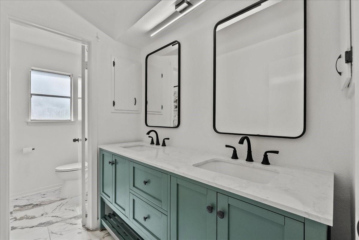 5762 Birdwood Road Houston, TX 77096 - Photo 19 of 49 THIS STYLISH UPDATED SECONDARY BATH WITH DUAL SINKS AND SEPERATE TOILET/ SHOWER AREA IS VERY CONVENIENT.