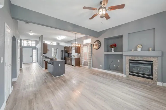a view of a kitchen with a sink and a fireplace