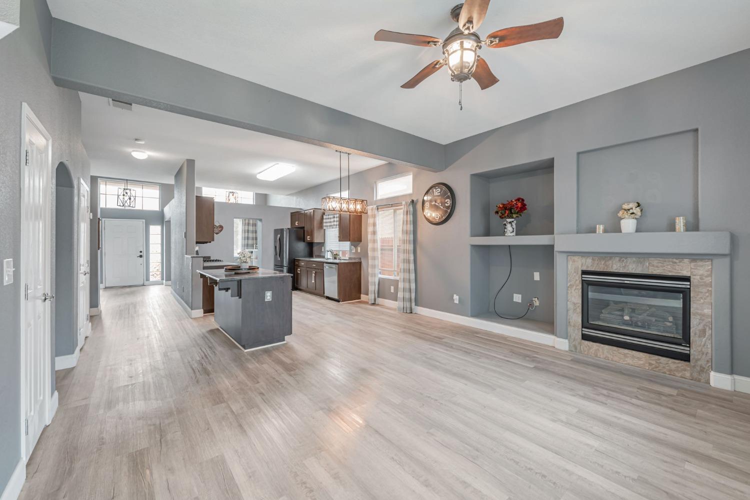 a view of a kitchen with a sink and a fireplace