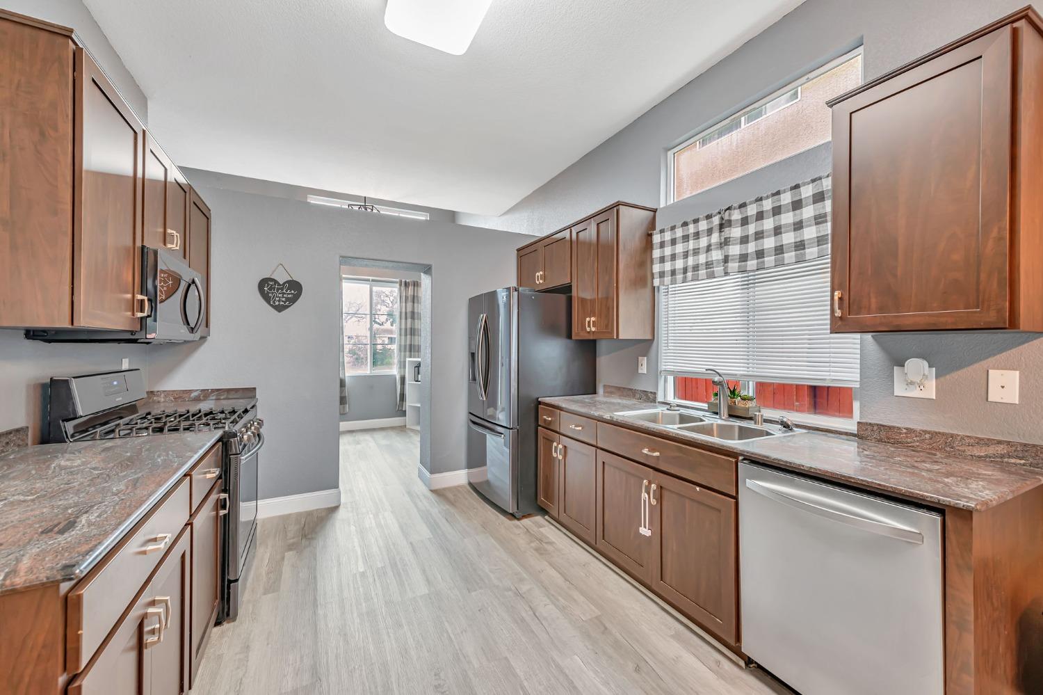9065 Robbins Road Sacramento, CA 95829 - Photo 11 of 45 a kitchen with stainless steel appliances granite countertop a sink stove and refrigerator