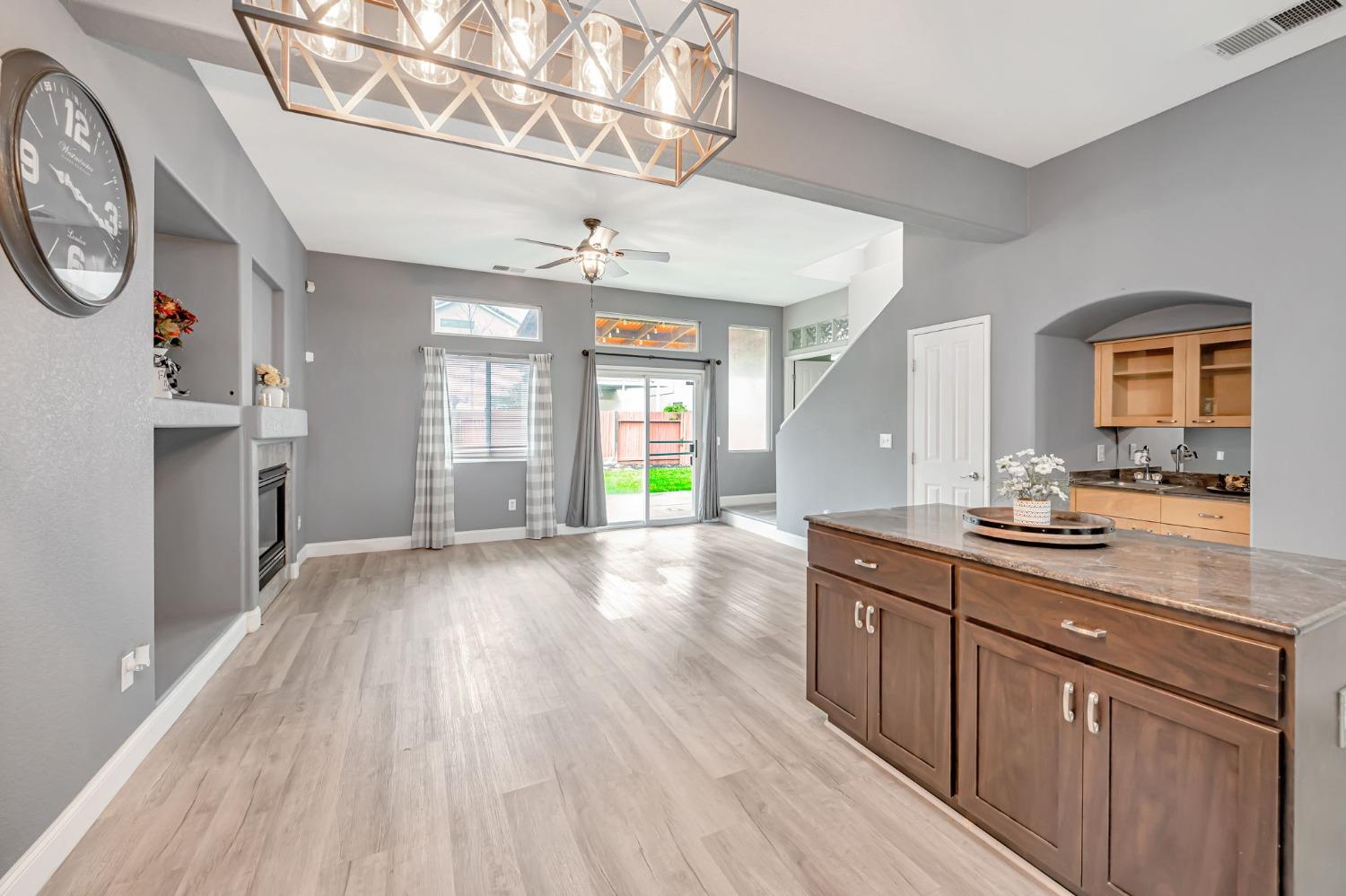 9065 Robbins Road Sacramento, CA 95829 - Photo 13 of 45 a large kitchen with a wooden floor