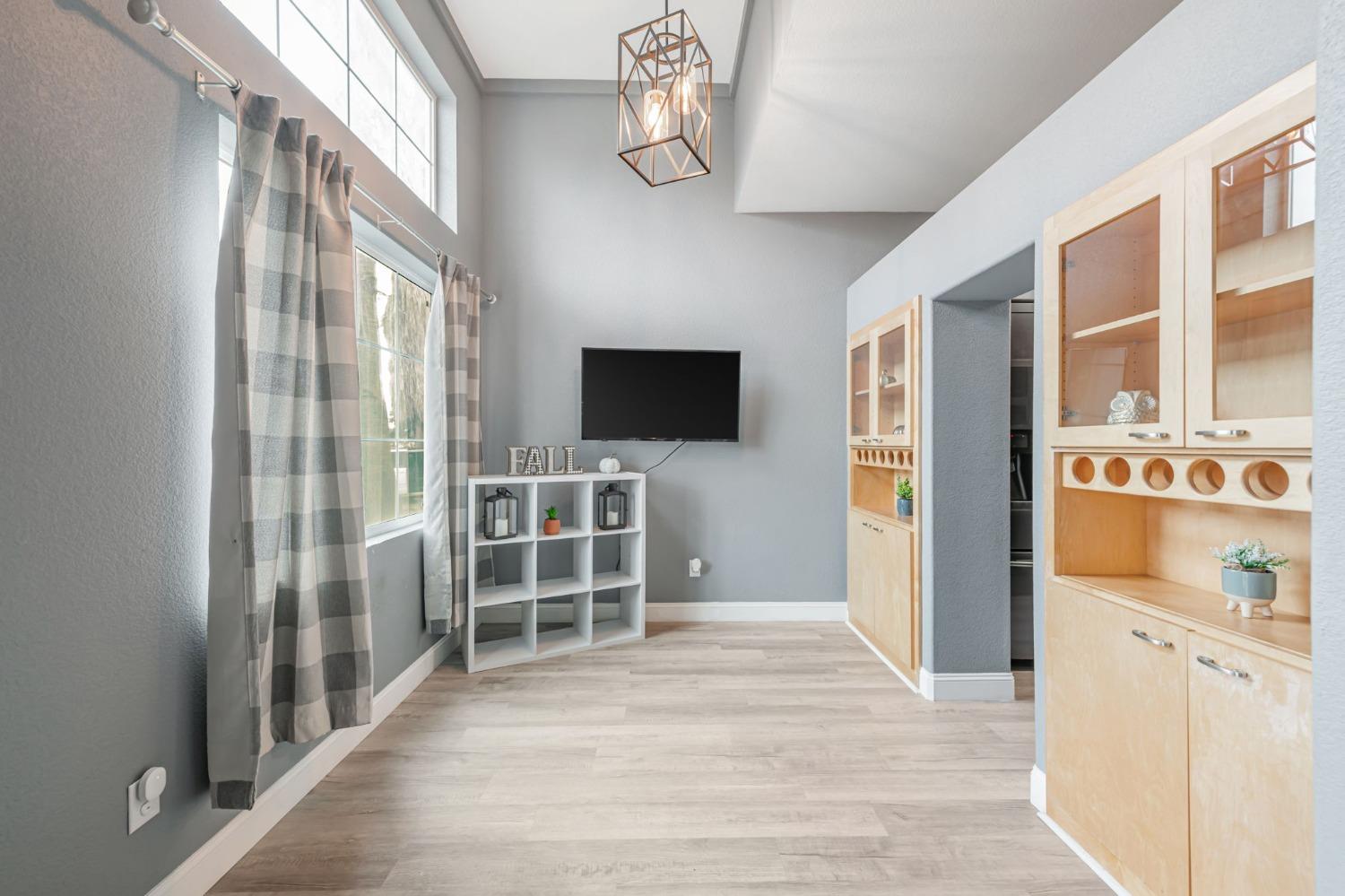 9065 Robbins Road Sacramento, CA 95829 - Photo 14 of 45 a view of a livingroom with wooden floor and a flat screen tv