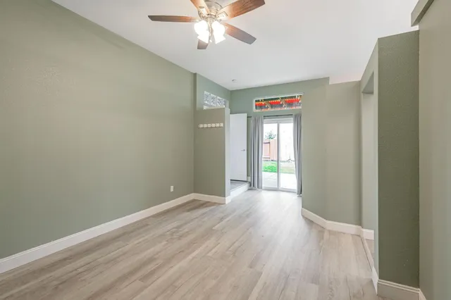 a view of empty room with wooden floor