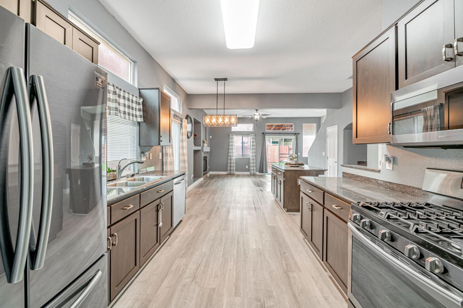 9065 Robbins Road Sacramento, CA 95829 - Photo 2 of 45 a kitchen with stainless steel appliances a sink stove and refrigerator