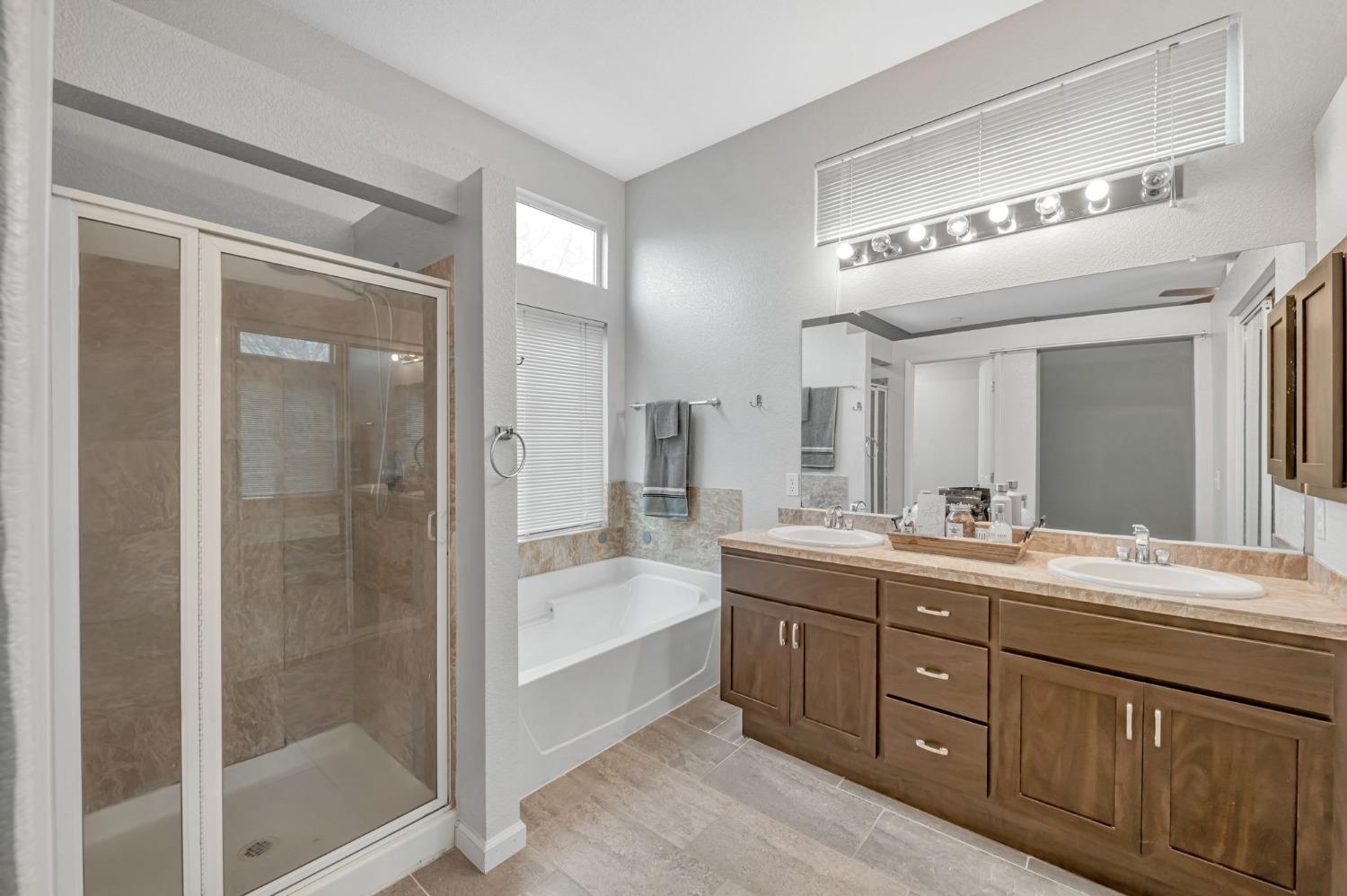 9065 Robbins Road Sacramento, CA 95829 - Photo 21 of 45 a bathroom with a double vanity sink a large mirror and shower