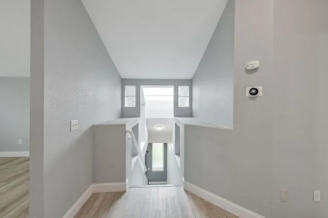 a view of a kitchen with wooden floor and electronic appliances