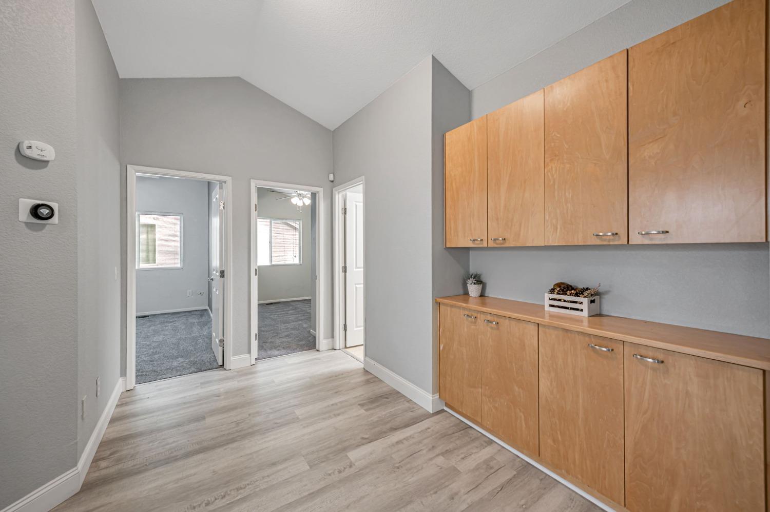 9065 Robbins Road Sacramento, CA 95829 - Photo 27 of 45 a view of a kitchen with wooden floor and cabinets
