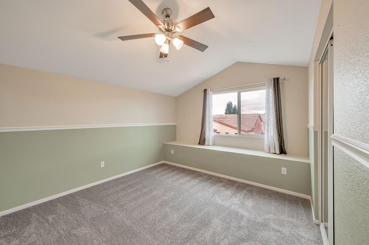 9065 Robbins Road Sacramento, CA 95829 - Photo 30 of 45 an empty room with a window and a ceiling fan