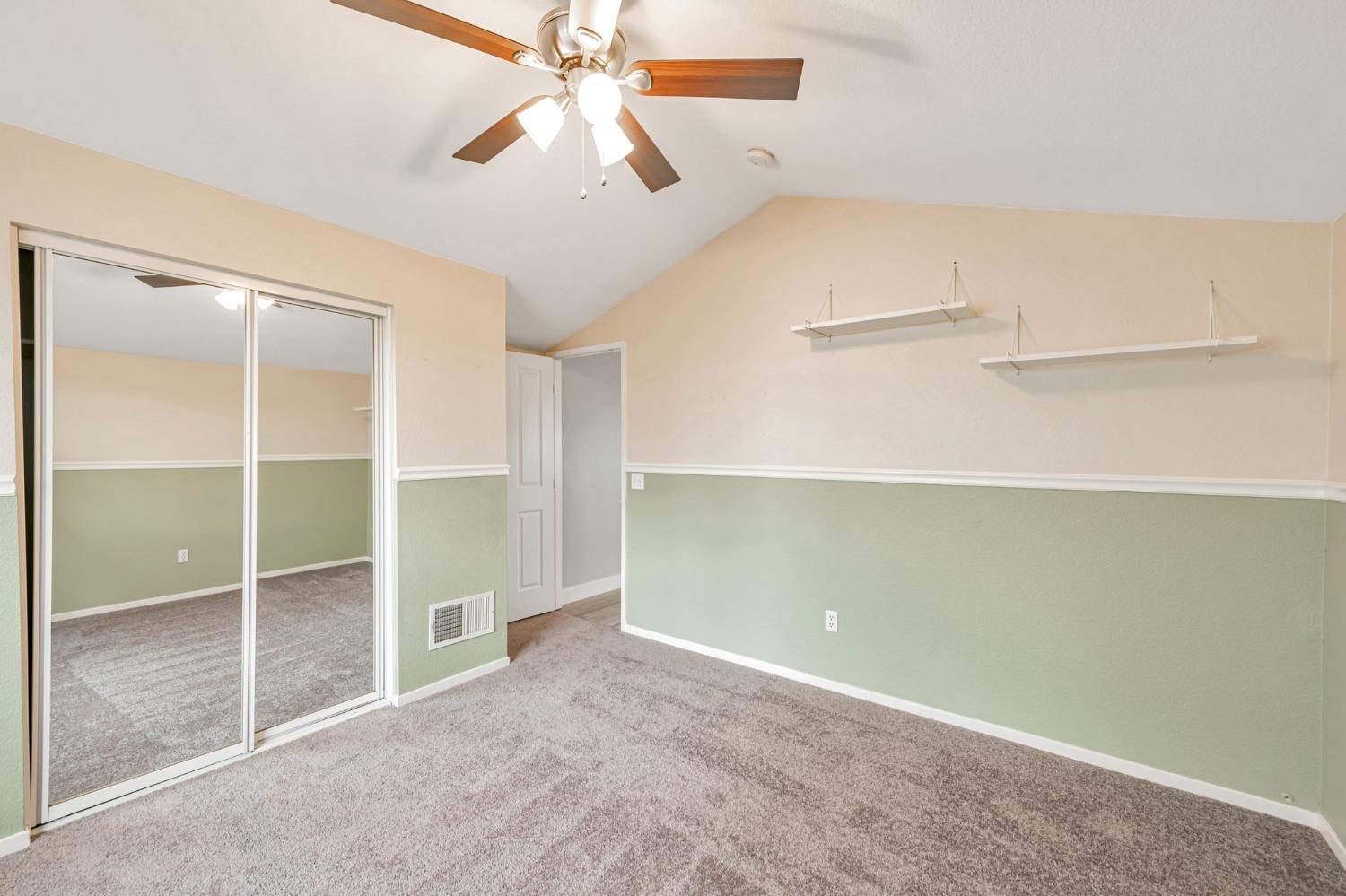 9065 Robbins Road Sacramento, CA 95829 - Photo 31 of 45 an empty room with closet and a chandelier fan