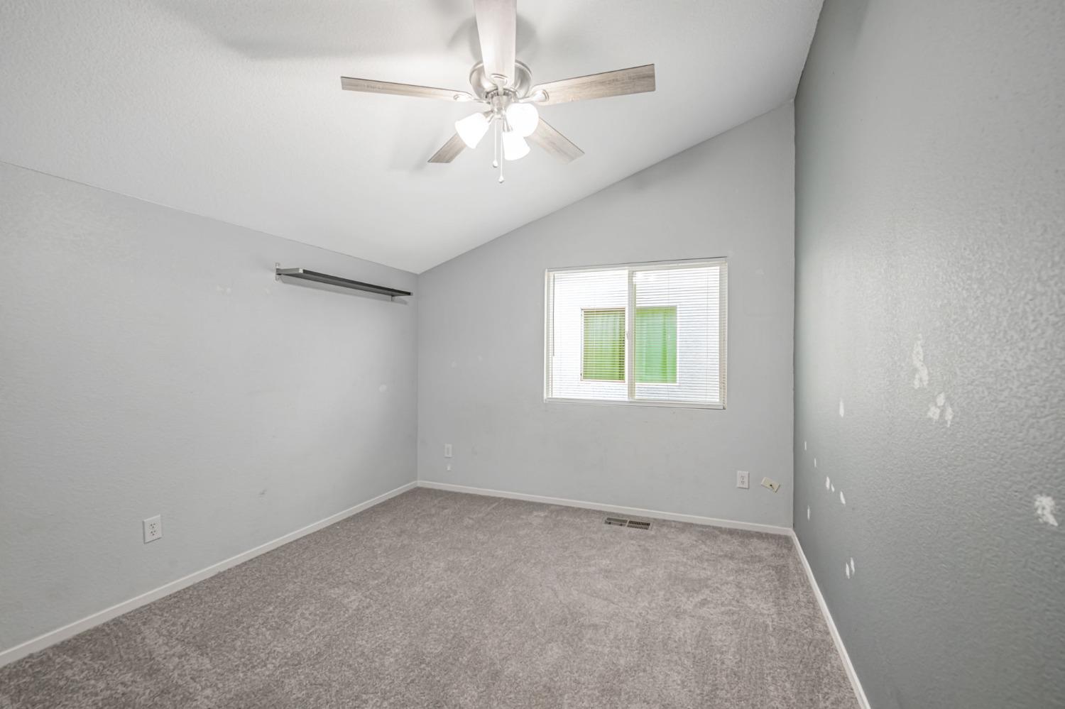 9065 Robbins Road Sacramento, CA 95829 - Photo 34 of 45 an empty room with a chandelier fan and windows