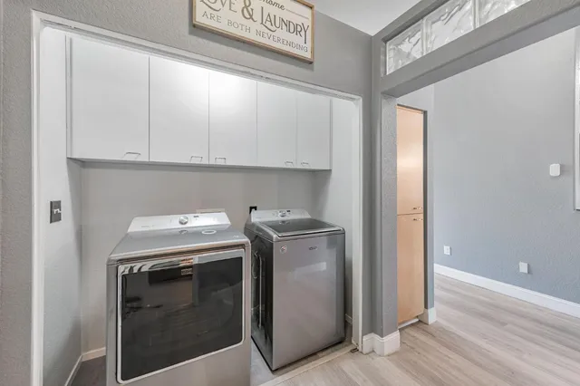 a kitchen with stainless steel appliances granite countertop a stove and a refrigerator