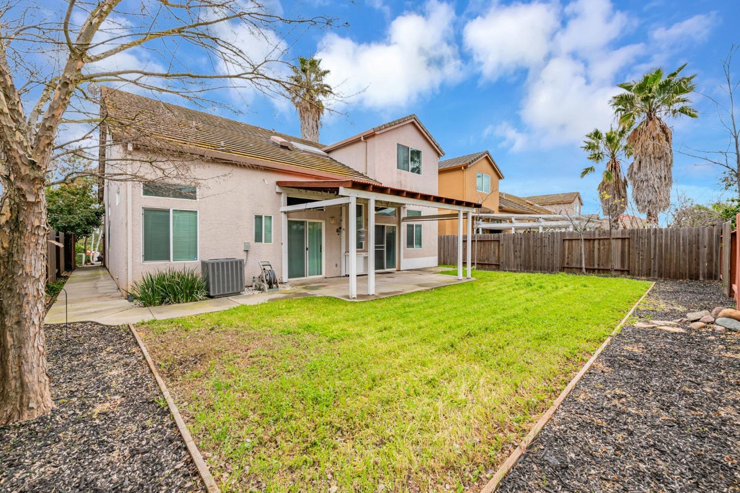 9065 Robbins Road Sacramento, CA 95829 - Photo 41 of 45 a view of a house with backyard and a patio